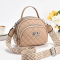 Beige quilted small round handbag with bow detail and woven jacquard shoulder strap - Khaki