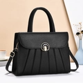 Black pebbled leather tote bag with accordion pleats and round metal lock for women - Black