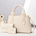 Close-up of three-piece cream tote set with woven pattern and golden metal hardware - Off White