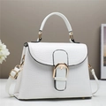 Detail of white faux crocodile texture handbag with large gold horseshoe metal buckle - White