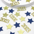 Close-up of gold 2023 glitter numbers and blue stars for New Year table decoration - Blue Gold Star and Gold Glitter 2026 Confetti