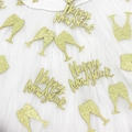 Close-up of golden glitter Happy New Year and champagne cup confetti on white fur - Gold Glitter Wine Glass and Happy New Year Confetti