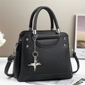 Close-up of black lychee grain leather handbag with silver hardware and star pendant - L25 W11 H21 / Black