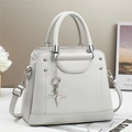 Light gray lychee leather crossbody bag with dual handles and star charm ornament - L25 W11 H21 / Off-white