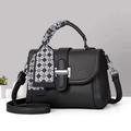 Detail of black pebbled leather handbag featuring a stylish checkered silk scarf on handle - 23x10x17 / Black