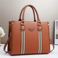Close-up of brown litchi pattern leather tote bag with red and black striped ribbon detail - Khaki/Earth Yellow