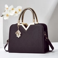 Structured black leather handbag with geometric texture and gold V-shaped hardware - Coffee