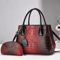 Detail view of red and black gradient handbag with crocodile texture and matching coin purse - Wine Red