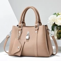 Detail of beige lychee leather handbag with metal lock and mini envelope charm - L29 W12 H21 / Khaki