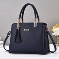 Kaiweilu dark blue litchi leather handbag with gold hardware and tassel detail - Blue