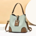 Minimalist mint green bucket bag with brown leather trim and golden D-letter charm - Green