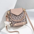 Chic pink patchwork crossbody mini bag with gold hardware and plush charm on white stands - Khaki