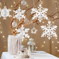 Detailed view of 3D white paper snowflake ornaments hanging on festive winter branches - 6Pcs 3D White Snowflake Ornaments (Sewn Line Style)