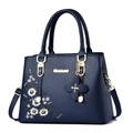 Navy blue faux leather handbag with floral embroidery and adjustable shoulder strap - Blue