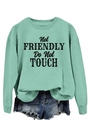 Detail of mint green sweatshirt with Not Friendly Do Not Touch text and frayed denim shorts - S / Light Green (Black Slogan)