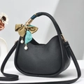 Fashionable black lychee grain hobo bag with silk scarf handle and pearl pendant detail - Black