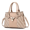 Close-up of golden padlock pendant and monogram texture on a beige fashion handbag - Cream White Wave Pattern