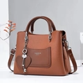 Chic tan pebbled leather handbag with contrast pocket and silver heart charm pendant - Khaki/Earth Yellow