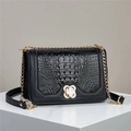 Elegant black crocodile pattern crossbody bag with gold chain and clover buckle detail - Black