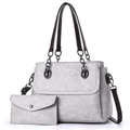 Detail view of grey tote bag set with matching wallet and adjustable brown strap - Light Gray