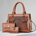 Close-up of glossy brown three-piece handbag set with crocodile texture and gold hardware - Khaki/Earth Yellow