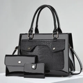 Detailed view of black patent leather 3-piece bag set with crocodile texture embossing - Black