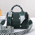Detail of dark green leather handbag with floral silk scarf handle and golden clasp - Green