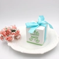 Detail of white hollow baby stroller favor box with light blue satin ribbon on ceramic plate - Baby Stroller / No Ribbon / Green