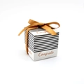 Detail of square black and white striped gift box with gold Congrats text and ribbon bow - With Ribbon