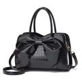 Glossy black crocodile pattern handbag for women featuring a large bow and shoulder strap - Black