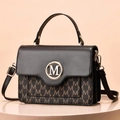 Elegant two-tone brown monogram handbag with gold M logo and adjustable black strap - Coffee
