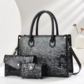 Detailed macro view of black embossed floral pattern on luxury faux leather 3-piece bag set - 3-Piece Set (28x11x21cm) / Black