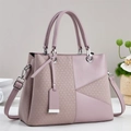 Detail view of pink textured leather handbag with braided panel and silver hardware - 29/12/22 / Purple