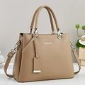 Detail view of khaki leather handbag featuring pebble texture and fashion bags logo - Khaki