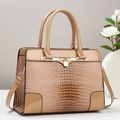 Detail of crocodile pattern texture and gold metal buckle on beige leather handbag - 30x13x23cm / Khaki