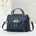 Dark blue leather handbag with golden flamingo buckle and metal round handles - Blue