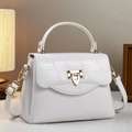 Close-up of white croc-embossed leather handbag with elegant gold metal buckle - 24x10x16cm / White