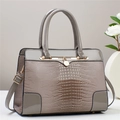 Elegant grey crocodile embossed handbag with glossy faux leather and golden metal hardware - Gray