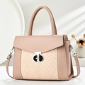 Close-up of pink tote bag featuring woven texture panel and geometric metal lock detail - Pink