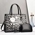 Detailed view of leopard print tote bag with small black pouch and plush charm - Black