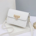 Elegant white quilted heart crossbody bag with gold floral pendant on a minimalist stand - White