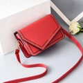 Red crossbody chain bag in synthetic leather with V-flap design and golden logo - Stitched Red