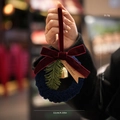 Blue plush Christmas wreath with red velvet bow, pine branches and gold bell decoration - Blue
