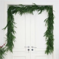 Green PE Christmas willow vine garland draped over a white double door frame - Willow Leaf Garland Naked