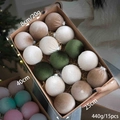 Detailed view of 8cm velvet Christmas baubles in neutral tones being held by a hand - Green System