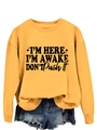 Detail of yellow sweatshirt featuring black I'M HERE I'M AWAKE slogan text print - Yellow (Black Font)