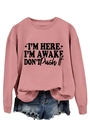 Detailed view of the pink sweatshirt ribbed cuffs and 'I'm Here' slogan print - Rose Gold (Black Font)
