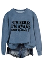 Close-up of blue sweatshirt with I'm Here I'm Awake text and frayed denim shorts - Blue (Black Font)