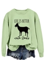 Close-up of light green sweatshirt featuring black goat silhouette and slogan - Olive Green (Black Font)
