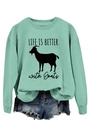 Detail of mint green crewneck sweatshirt with Life Is Better with Goats print and denim shorts - Light Green (Black Text)